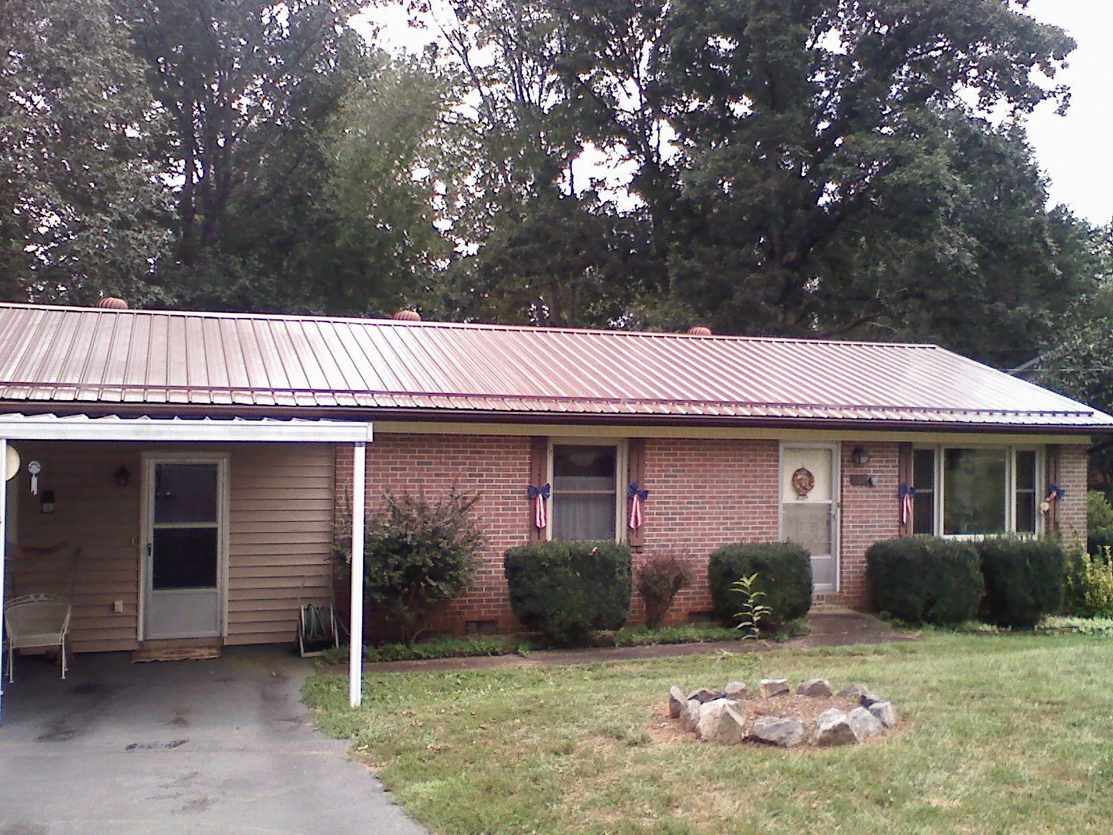 Bronze metal roof and carport on a brick ranch home — Roof Repair work by our crew in Fox Lake